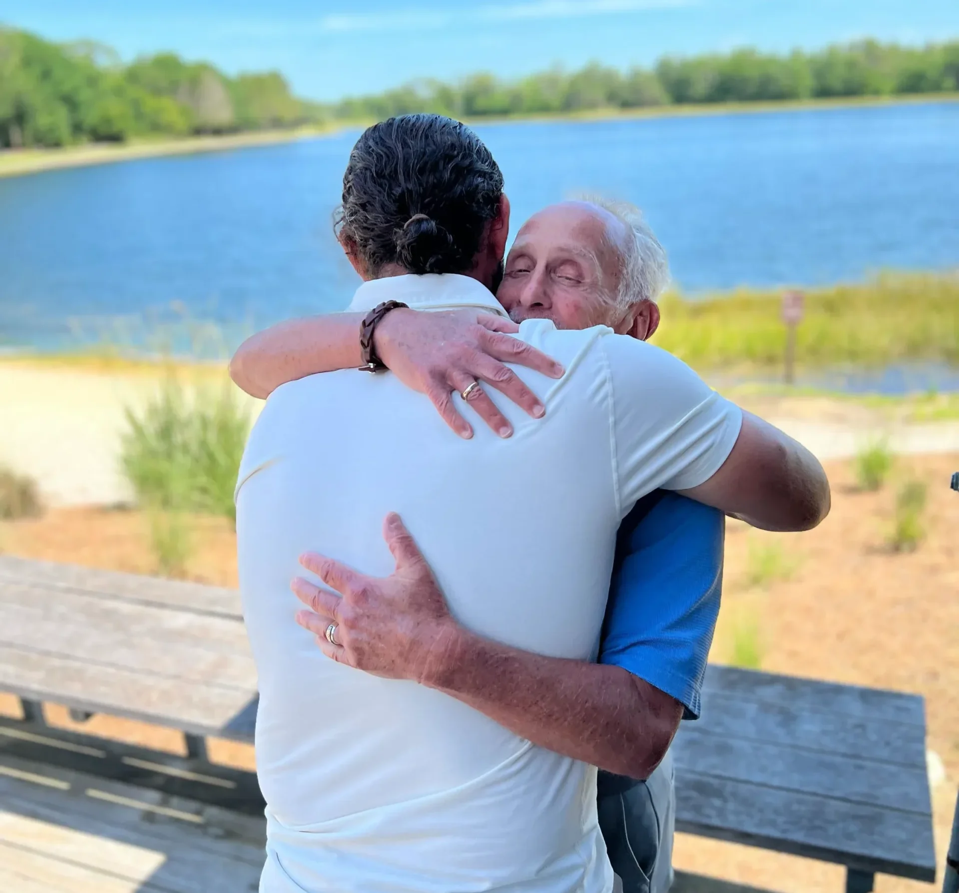 Father-and-son Medicare team, Jesse and Arnie, hugging.