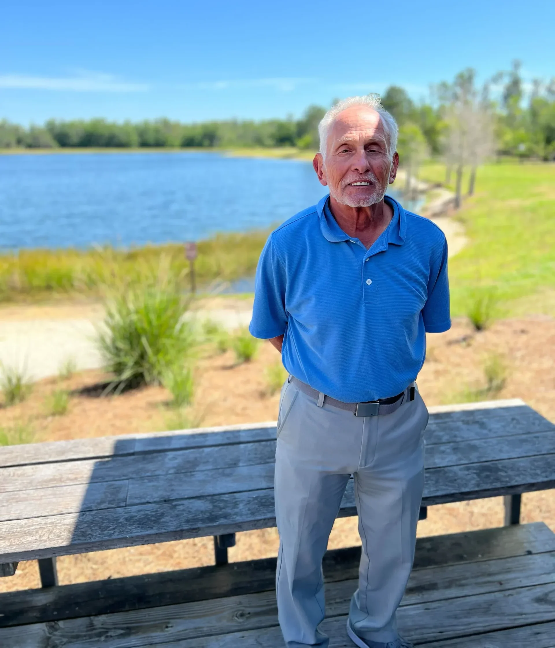 Arnie Peltz, Plans Plus for Seniors Founder, standing outdoors in near a pond.