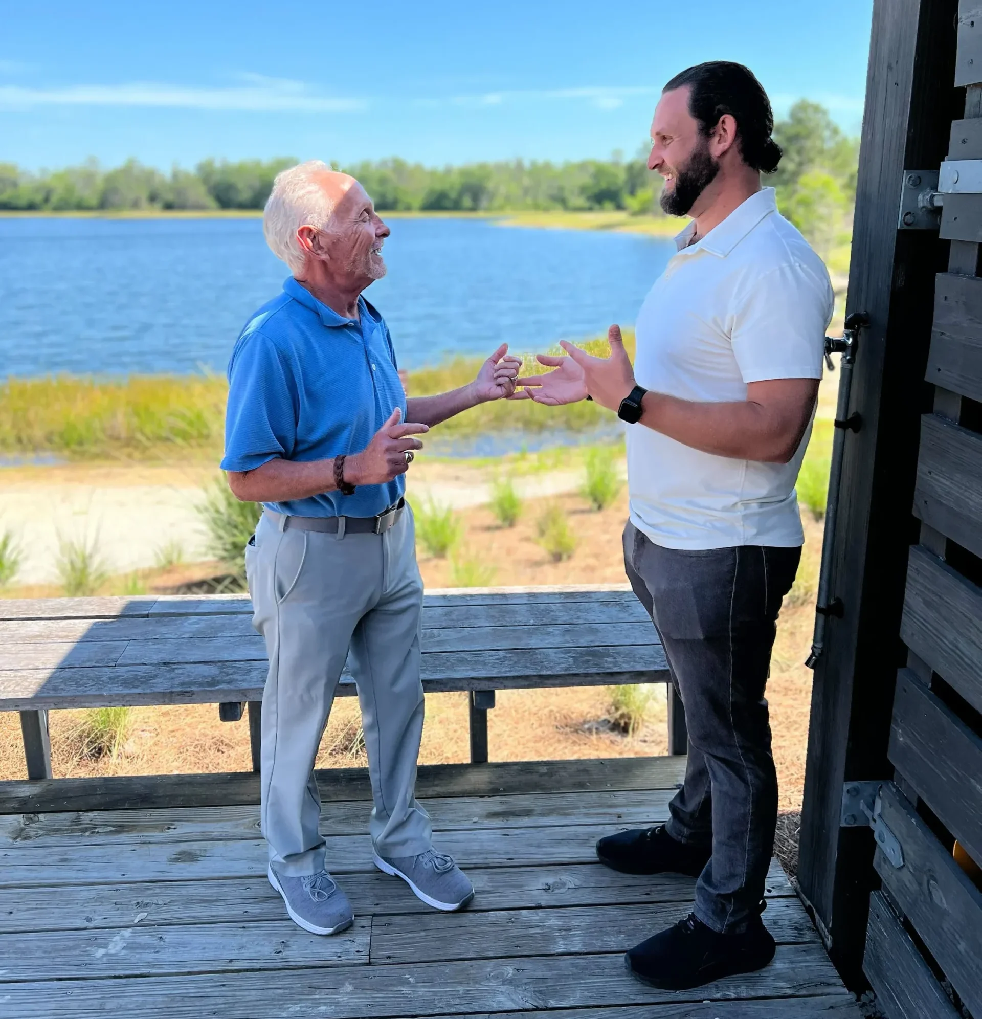 Jesse and Arnie, the 'Medicare Whisperer,' chatting outdoors.