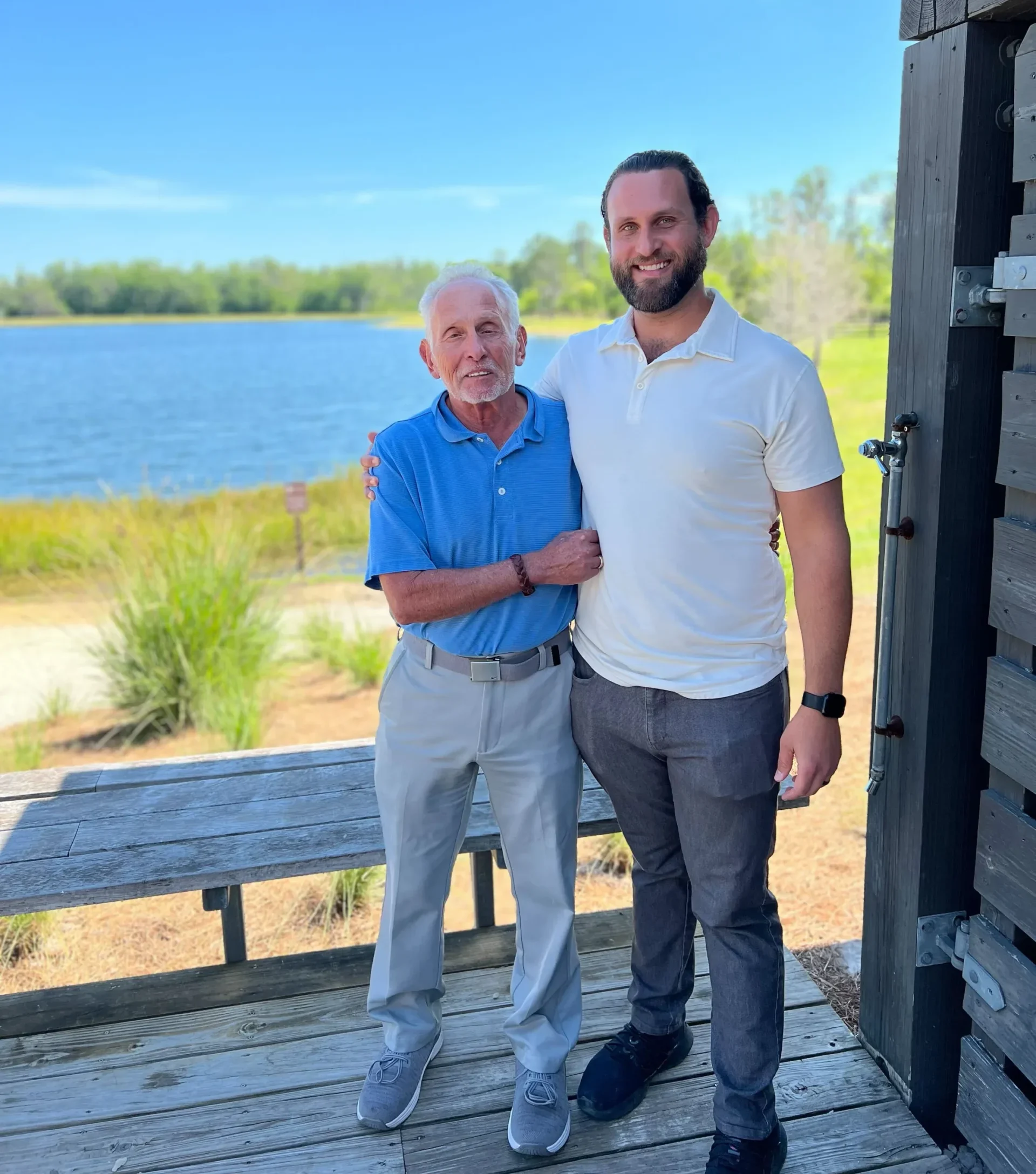 Arnie and Jesse side-by-side at a lake.